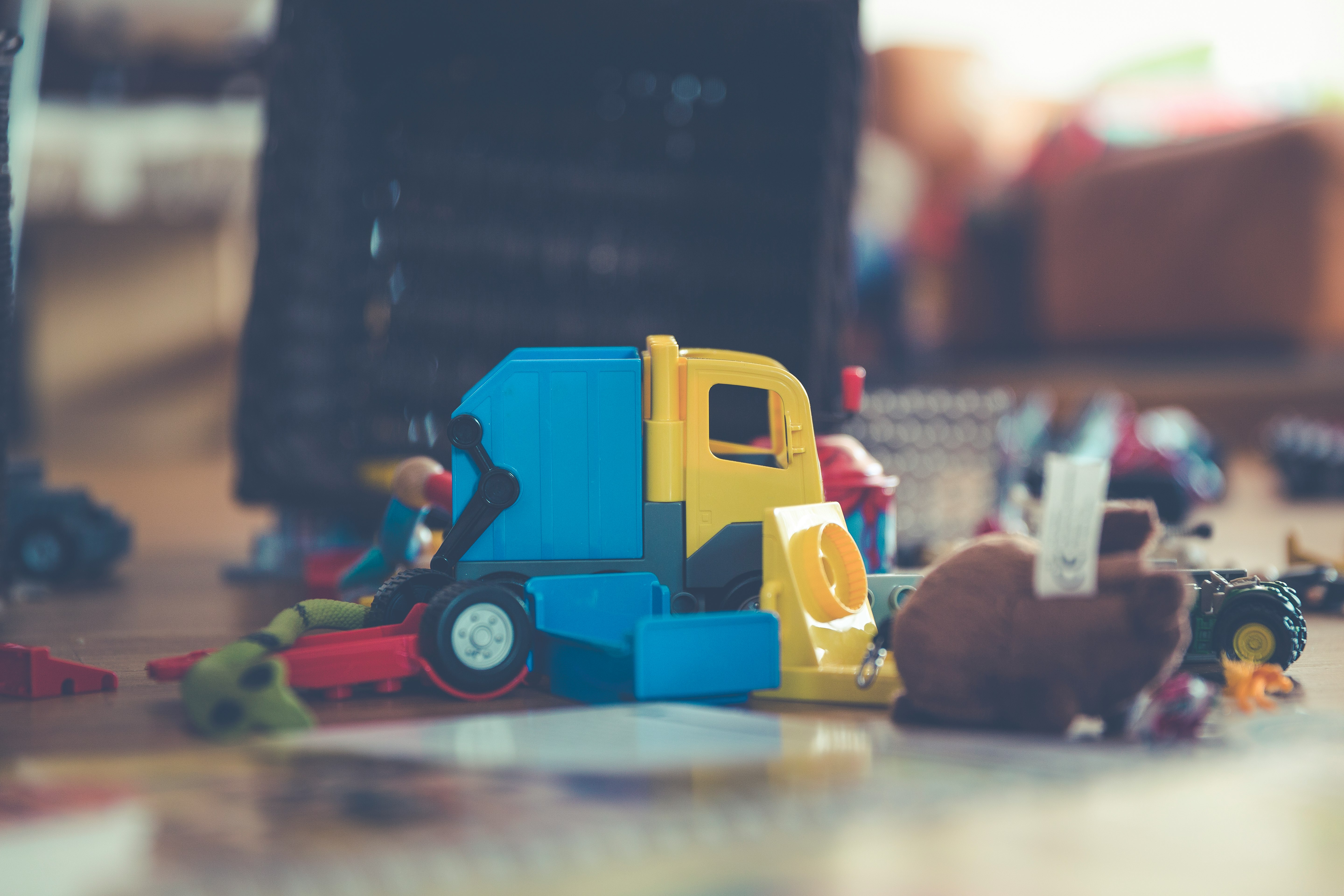 assorted-color toys on gray concrete paving